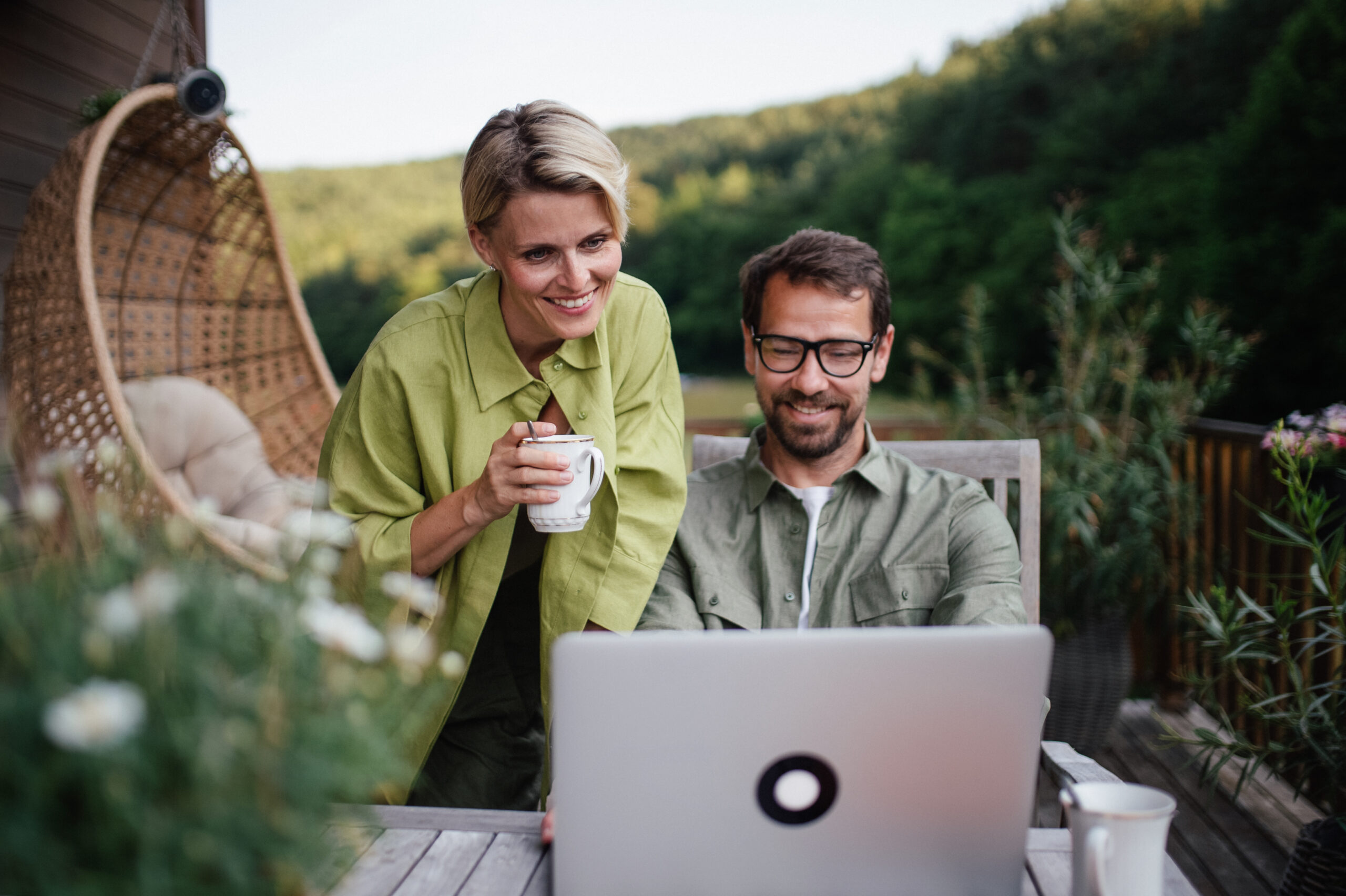 Beautiful wife looking at laptop screen of her husband Couple shopping together looking for vacation | Smoobu