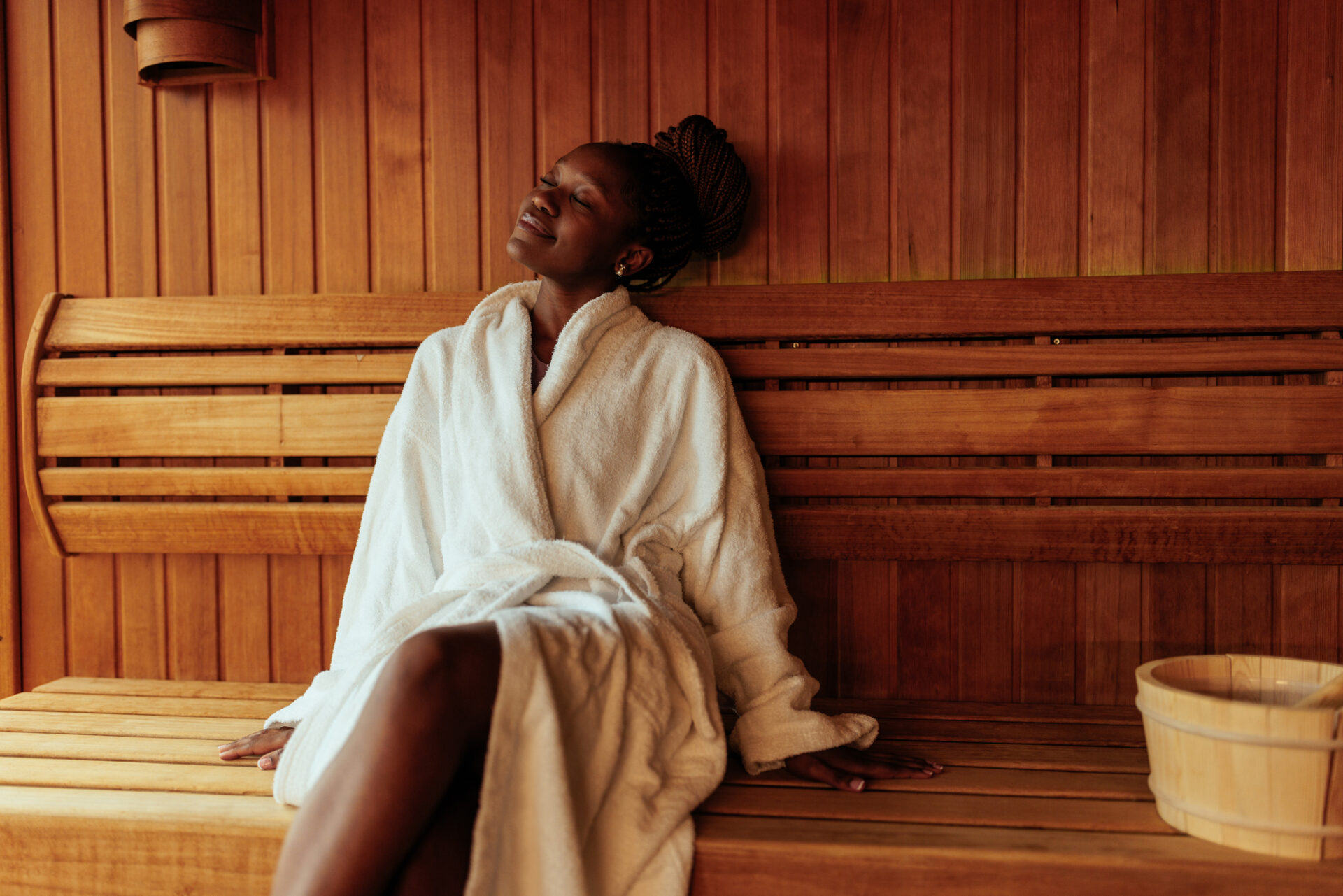 Young black woman enjoying in sauna | Smoobu